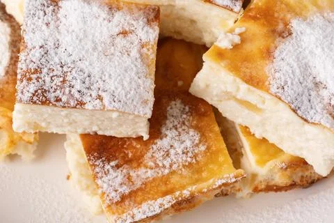 Cottage cheese bars dusted with powdered sugar, showcasing a golden Stock Photos