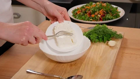 Cottage cheese is mixed with a fork in a plate Stock Footage 253550034