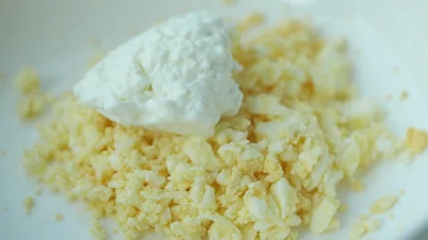 Cottage Cheese Mixed with Mashed Boiled Eggs in White Bowl Stock Footage 343733606