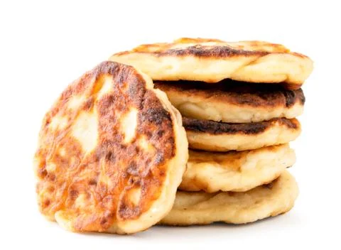 Cottage cheese pancakes in a close-up stack. Isolated on a white Stock Photos