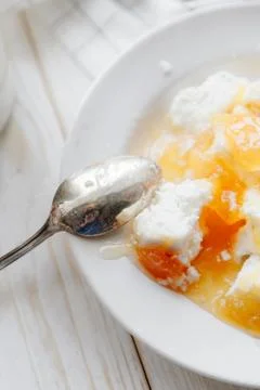 Cottage cheese with peach jam Stock Photos
