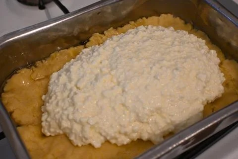 Cottage cheese pie preparation in a baking tray Photos