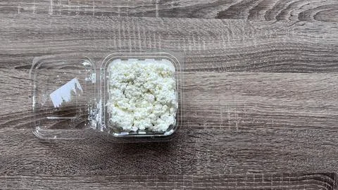 Cottage cheese in plastic container Stock Photos