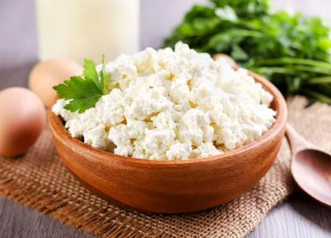 Cottage cheese in a plate on the table, serving cottage cheese. Food photo Stock Photos