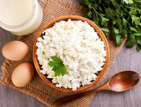 Cottage cheese in a plate on the table, serving cottage cheese. Top view Stock Photos