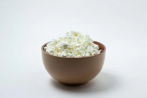 Cottage cheese on a white background. Stock Photos