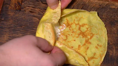 Cottage cheese is wrapped in a pancake Stock Footage 251721149
