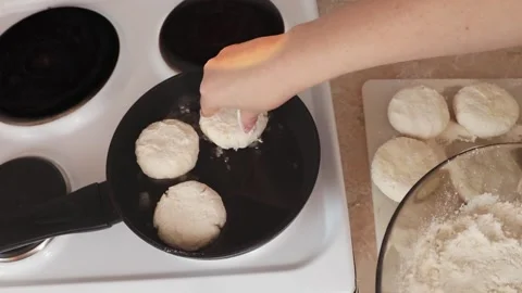 Cottage cheesecakes are fried in a frying pan. Stock Footage 232952729