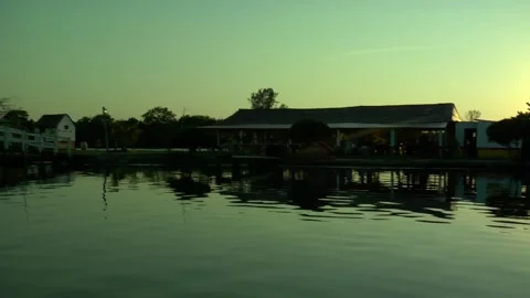 Cottage on lake at sunset Stock Footage 137550059