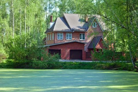 Cottage on a lakeside Stock Photos