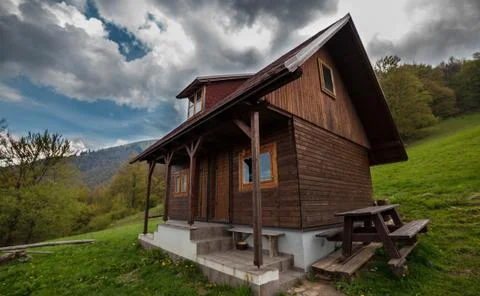 Cottage in mountains Stock Photos