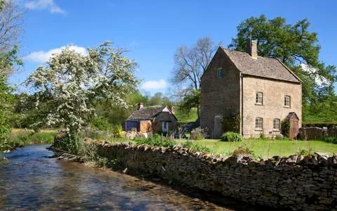 Cottage by a river Stock Photos