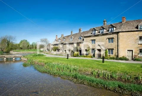 Cottages by a stream Stock Photos
