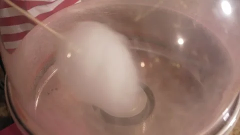 Cotton candy being spun inside machine Stock Footage 306344708
