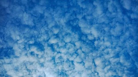 Cotton candy clouds in the blue sky Stock Photos