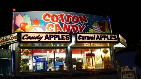 A Cotton Candy concession stand at a county fair at night Stock Footage 79335301