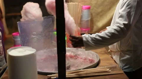 Cotton candy machine creates strands of sugar. Making pink cotton candy in a 库存影片 61284507