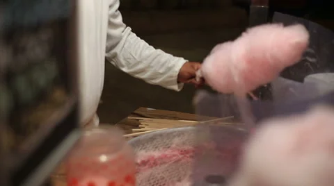 Cotton candy machine creates strands of sugar. Making pink cotton candy in a Stock Footage 61284828