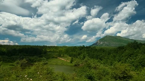 Cotton-like clouds drift across the horizon. Vrmdza Lake, Serbia Vídeos de archivo 338025329