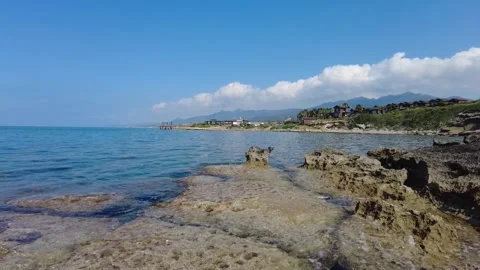 Cotton-like clouds rising over the mountain, the holiday village and the pier. Stock Footage 278106898