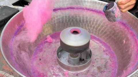 Cotton machine working and hand filling blue sugar Stock Footage 124379109