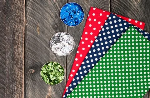 Cotton polka dots textile for needlework and glitter on old wooden backgrou.. Stock Photos
