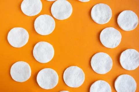 Cotton sponges pattern on orange background, minimal concept, copy space Stockfoto's