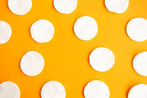 Cotton sponges pattern on orange background, minimal concept, copy space Stock Photos