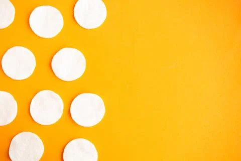 Cotton sponges pattern on orange background, minimal concept, copy space Stockfoto's