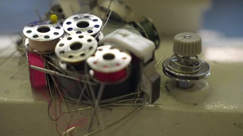 Cotton thread bobbins, needles and fabric straight pins on magnet in tailor's Stock Footage 256575028