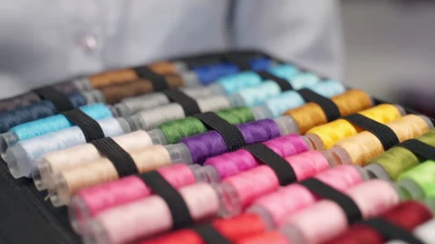 Cotton thread bobbins of rainbow colours and shades used in sewing industry Stock Footage 305159790