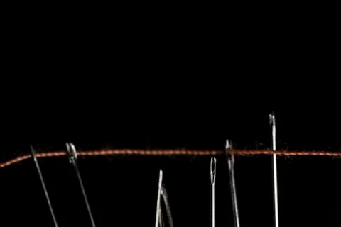 Cotton thread on needles macro closeup Foto stock
