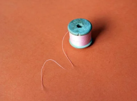 Cotton thread reels bobbin spool pink and blue on bright background copy space Stock Photos