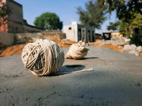 Cotton thread roll on wall on a construction site Stock Photos