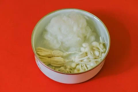 Cotton wicks made with pure white cotton in cup isolated red background Stock Photos