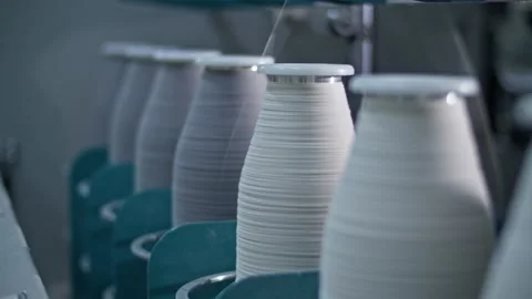 Cotton yarn on bobbin. Spool of thread closeup on clothing factory. Textile Video stock 221179419