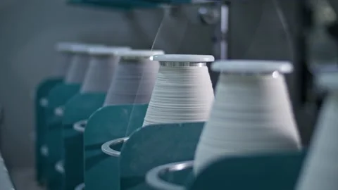 Cotton yarn on bobbin. Spool of thread closeup on clothing factory. Textile Video stock 221179454