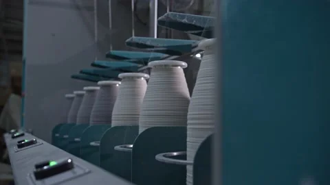 Cotton yarn on bobbin. Spool of thread closeup on clothing factory. Textile Video stock 222133427