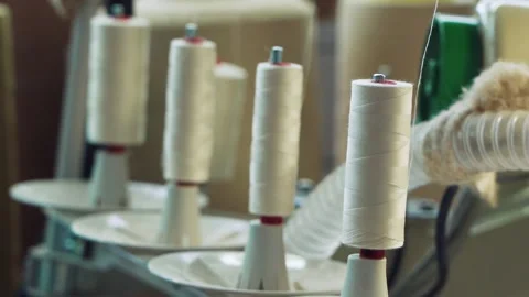 Cotton yarn on bobbin. Spool of thread closeup on clothing factory Stock Footage 234204901