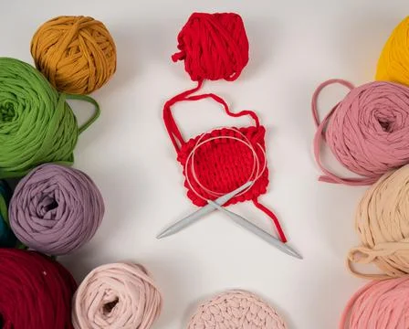 Cotton yarn knitting pattern on white table. Stock Photos