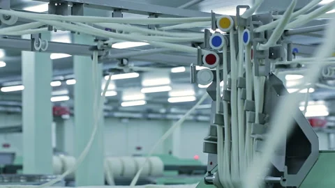 Cotton yarn moves along the rollers of spinning machines. Textile factory Stock Footage 247185518