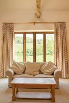 Couch and Coffee Table in Front of Patio Doors Stock Photos