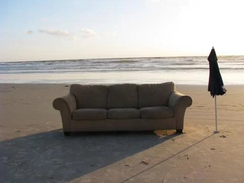 Couch on a beach Stock Photos
