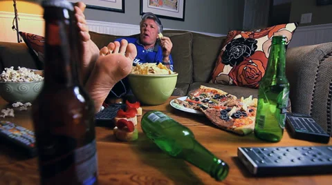 COUCH POTATO WITH FEET UP Video stock 32375417