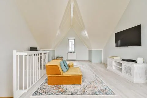 Couch with TV on mansard Stock Photos