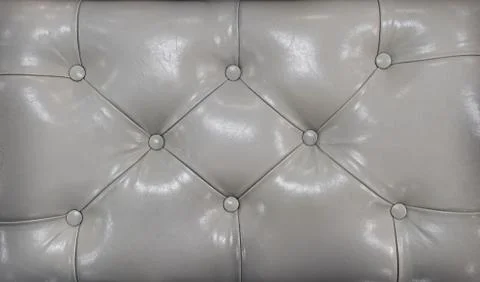 Couch-type screed. Retro light coloured chesterfield style quilted upholstery Stock Photos