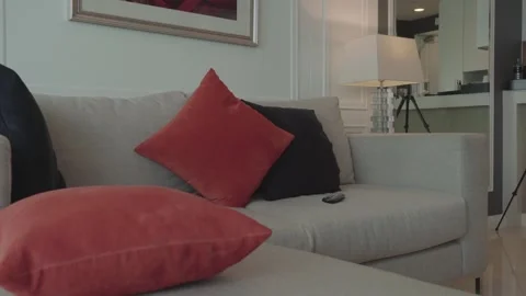 A couch with a white cushion and two red pillows Stock Footage 313554311