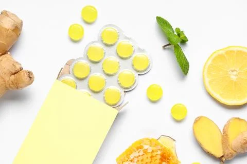 Cough drops in blister with ginger root, lemon slice, mint leaves and honeyco Stock Photos