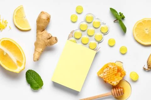 Cough drops in blister with ginger root, lemon slices, mint leaves and honey  Stock Photos