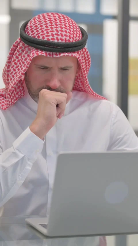 Coughing Arab Man Using Laptop in Office, vertical video Video stock 324777230